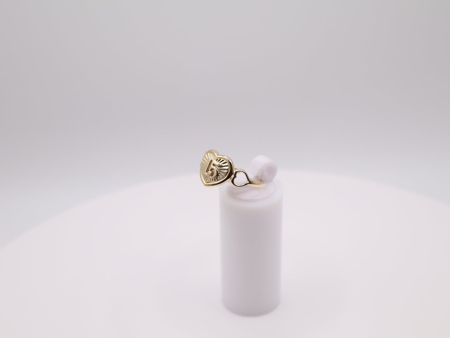Gold earring with a pearl on a white background