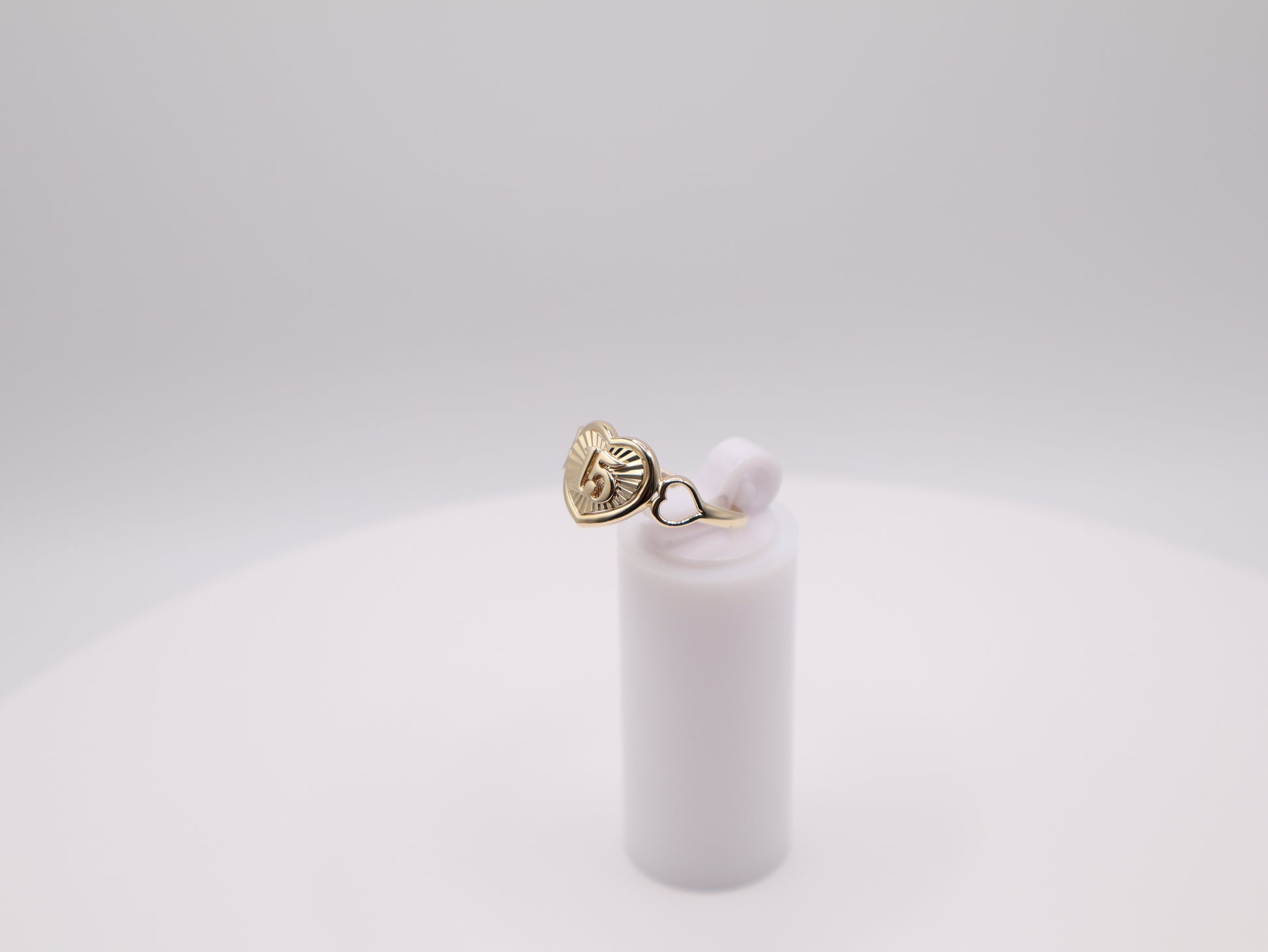 Gold earring with a pearl on a white background