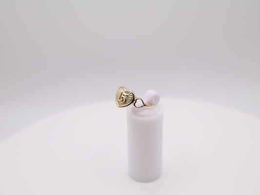 Gold earring with a pearl on a white background