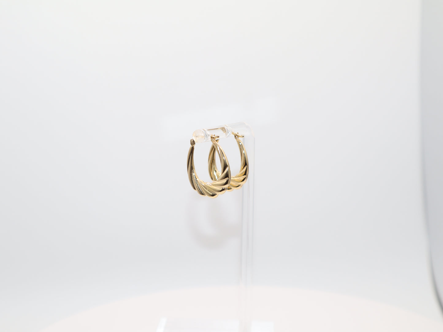 Gold hoop earrings on a white background
