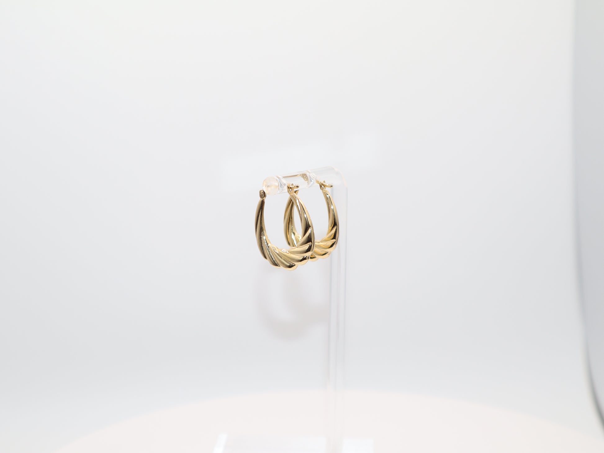 Gold hoop earrings on a white background