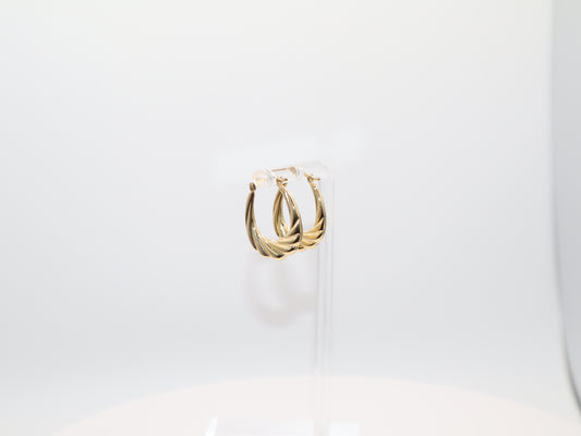 Gold hoop earrings on a white background