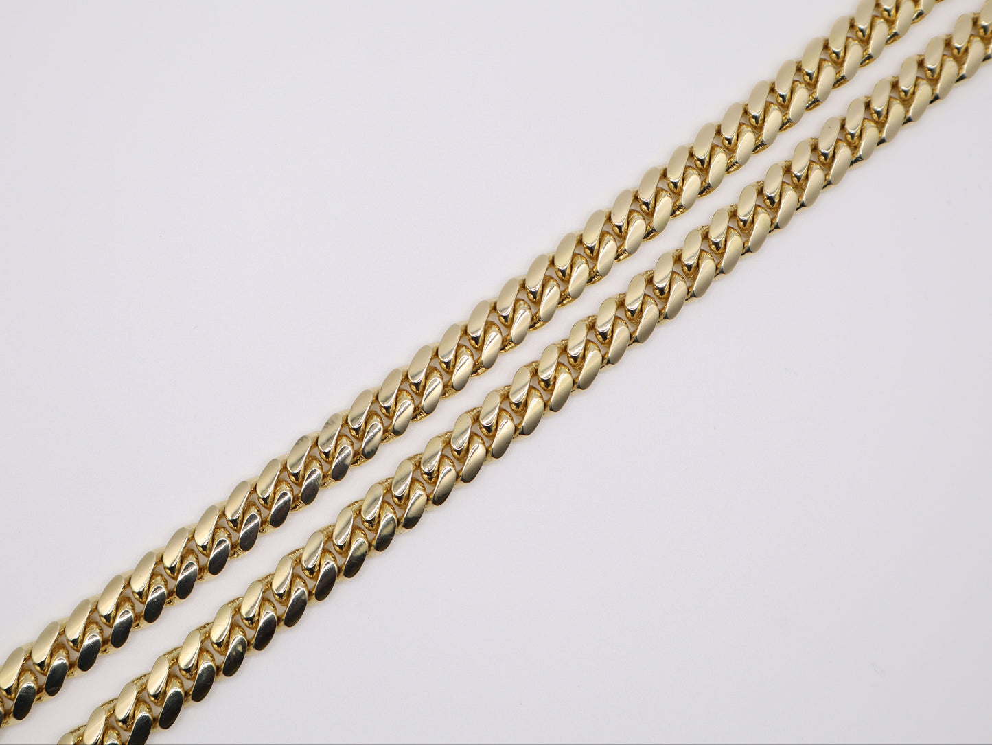 Gold chain on a light gray background
