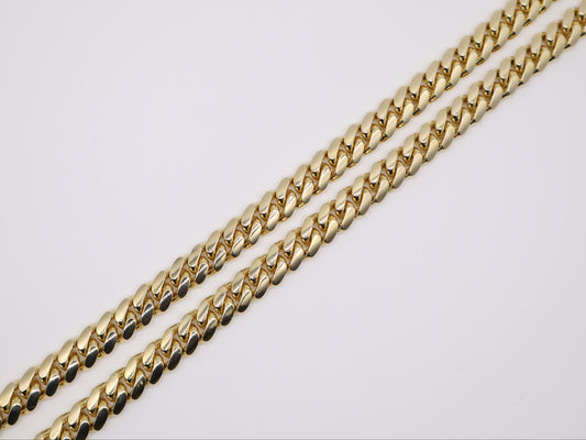 Gold chain on a light gray background