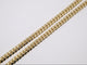 Gold chain on a light gray background